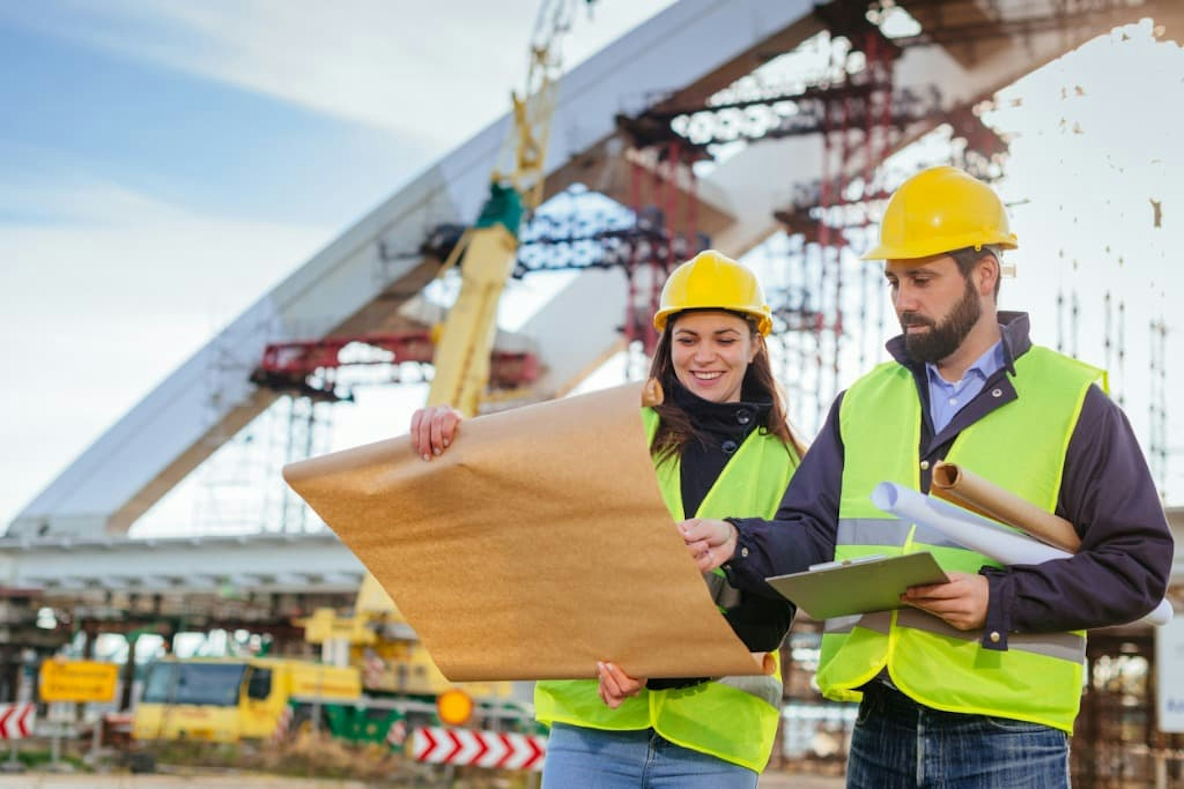 Two civil engineers looking at plans at work side