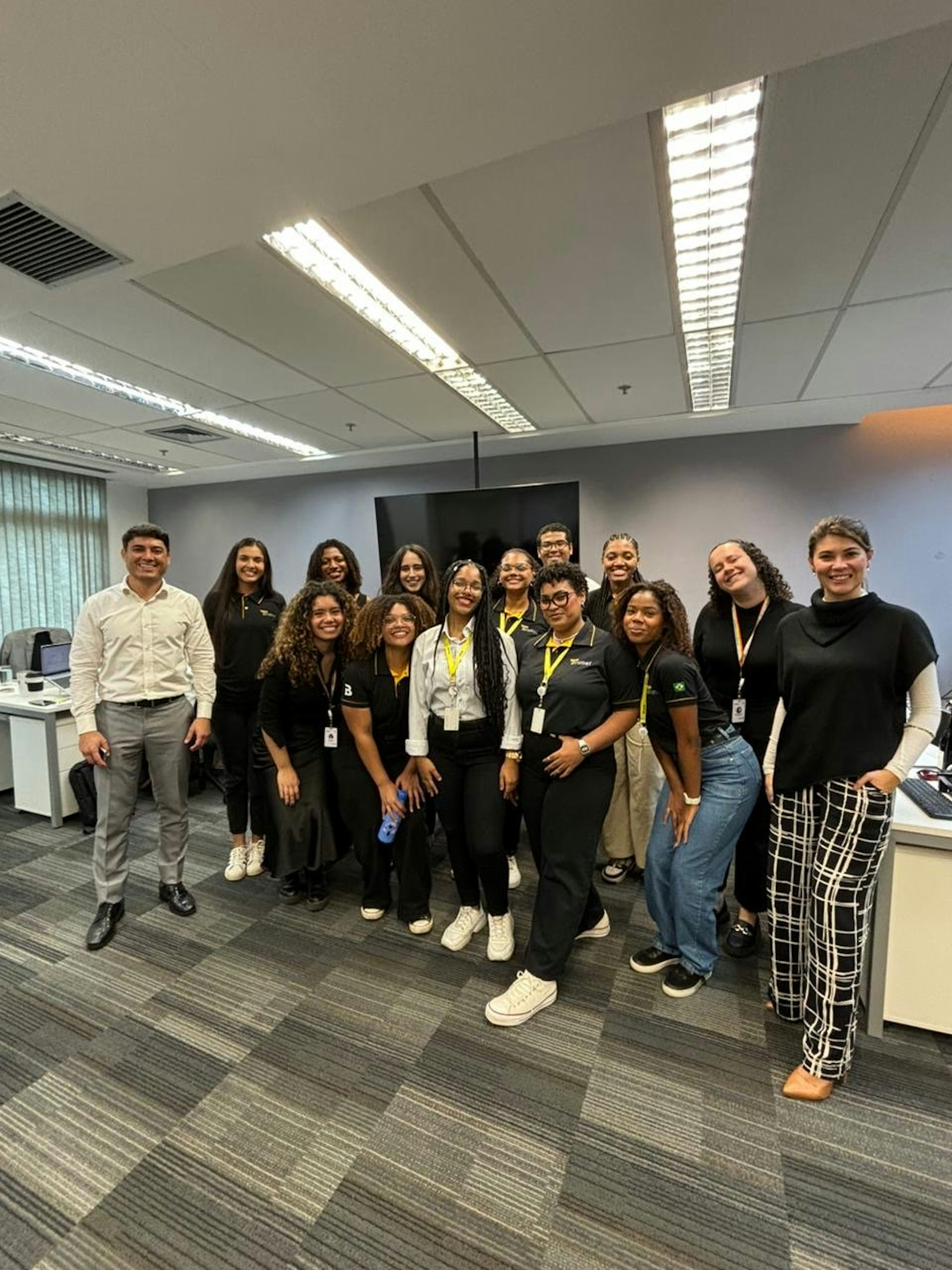 The Young Apprentice program members line up for a picture in the office as they prepare to start their first day learning about recruitment in Brazil